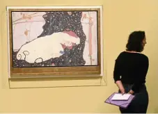  ??  ?? A visitor stands by an artwork by Austrian artist Egon Schiele entitled Danae during a visit to the Fondation Louis Vuitton in Paris.