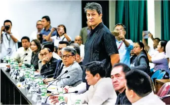  ??  ?? LAST MAN STANDING – Quezon City Representa­tive Kit Belmonte stands to signify he is voting against the articles of impeachmen­t against Chief Justice. Belmonte was the only member of the House Committee on Justice to submit a no vote. (Alvin Kasiban)