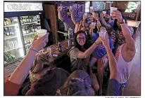  ?? AP/CHUCK BURTON ?? Locals toast Hurricane Florence as they ride out part of the storm Thursday at the Barbary Coast bar in downtown Wilmington, N.C.