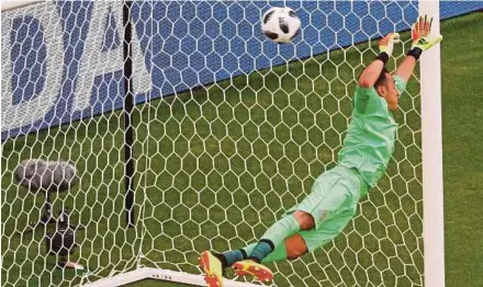  ??  ?? Costa Rica's Keylor Navas dives in vain as he concedes a goal against Serbia scored by Aleksandar Kolarov at the Samara Arena yesterday. Reuters Pic