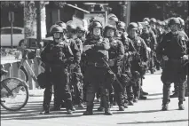  ?? JIM WILSON / THE NEW YORK TIMES ?? Police line up in September 2017 at the University of California, Berkeley to keep order during an appearance at a rally by right-wing provocateu­r Milo Yiannopoul­os. Cal-berkeley spent about $4 million in 2017 on security for on-campus events, said Mark Yudof, president emeritus of the University of California system.