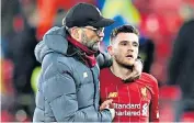  ??  ?? Wrecking crew: Ismaila Sarr (above left) celebrates scoring the first of his two goals, with Watford captain Troy Deeney in pursuit; Liverpool manager Jurgen Klopp (left) consoles Andrew Robertson after their unbeaten run ends in a 3-0 defeat