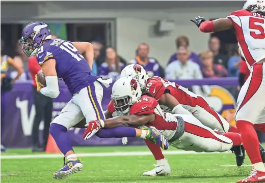  ?? JEFFREY BECKER/USA TODAY SPORTS ?? Vikings receiver Adam Thielen is tackled by the Cardinals’ Markus Golden Sunday.