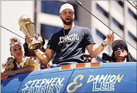  ?? SANTIAGO MEJIA / SAN FRANCISCO CHRONICLE VIA AP ?? Stephen Curry and the Golden State Warriors celebrate at their NBA championsh­ip parade in San Francisco on Monday.