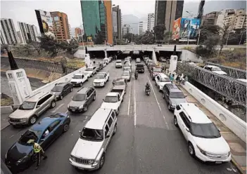  ?? ARIANA CUBILLOS/AP ?? Vehicles line up in May near a gas station in Caracas, Venezuela. Drivers could wait days in line to fill up their gas tanks.