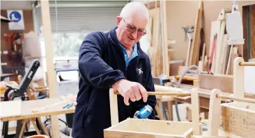  ??  ?? Graeme Rolfe of Drouin Men’s Shed finishes off items to sell at the open and market day.
