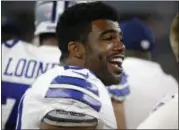  ?? RON JENKINS — ASSOCIATED PRESS ?? Cowboys running back Ezekiel Elliott laughs as he talks with teammates Aug. 19 during a preseason game.