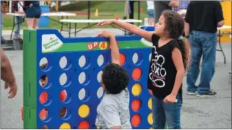  ?? MARIAN DENNIS — DIGITAL FIRST MEDIA ?? Kids played Connect Four and many other games during the celebratio­n of Rupert Elementary’s 90th birthday.