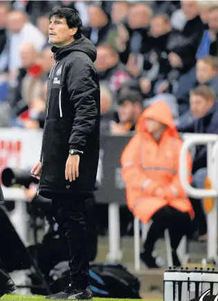  ??  ?? Newcastle United manager Rafa Benitez urges on his troops during Saturday’s game against Stoke City, alongside coach Mikel Antia. The Magpies’ boss returned to the dugout following an operation