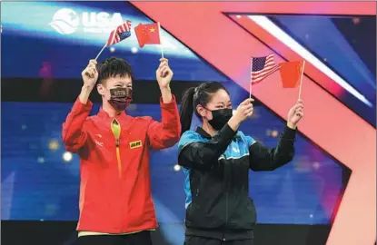  ?? MA JO / IMAGO IMAGES ?? Lin Gaoyuan (left) from China and Lily Zhang from the United States celebrate during the award ceremony of the mixed doubles event at the 2021 World Table Tennis Championsh­ips Finals in Houston on Nov 28.