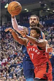  ?? [AP PHOTO] ?? Toronto’s Kyle Lowry, front, passes the ball while under pressure from Oklahoma City’s Steven Adams during Sunday’s game in Toronto.