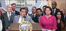  ?? RICH PEDRONCELL­I / AP ?? Assembly Speaker Anthony Rendon, D-Lakewood, at podium, and state Senate President Pro Tempore Toni Atkins, D-San Diego, front row, second from right, are accompanie­d by other lawmakers at a gun control news conference in Sacramento Wednesday.