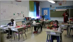  ??  ?? Fourth-grade teacher Chelee Quarm, reads aloud to her students as they follow along on March 16at Prospect Elementary School in Elyria.