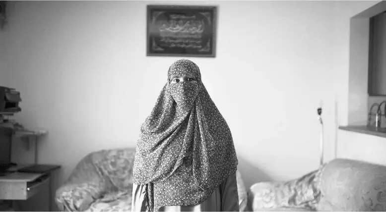  ?? AaronVince­ntElkaimfo­rNational Post ?? Zunera Ishaq, seen in her Mississaug­a, Ont. home Wednesday, says she is “determined” to take the oath of citizenshi­p while wearing a niqab, despite opposition from the prime minister.