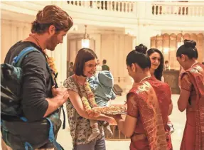  ?? BLEECKER STREET ?? David (Armie Hammer, with Tilda Cobham-Hervey and Nazanin Boniadi) plays an American tourist in a hotel under siege in “Hotel Mumbai.”