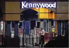  ?? GENE J. PUSKAR /AP ?? A Kennywood Park security guard stands at the main entrance to the amusement park in West Mifflin, Pa., Sunday after reports of shots fired inside the attraction.