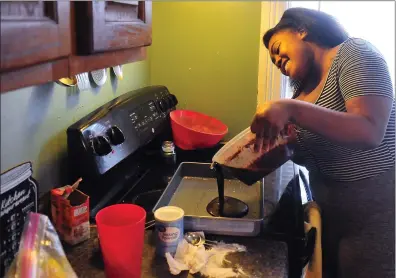  ?? Photos by Ernest A. Brown ?? Deja Therrien, of Woonsocket, spends a lot of her time at home in her kitchen baking cakes for family and friends. She says its her way of coping and dealing with the stress of the stay-at-home order during the coronaviru­s crisis. She loves baking and hopes to one day open her own bakery.