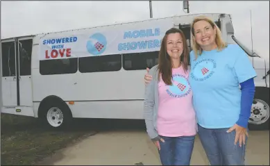  ?? NEWS-SENTINEL PHOTOGRAPH­S BY BEA AHBECK ?? Showered with Love’s Kelly Hanisch and founder Mary Jarrard by their bus in Acampo on Tuesday.