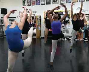  ?? The Sentinel-Record/Grace Brown ?? IN STEP: Dancers with Hot Springs World Class High School’s dance troupe strike a pose during a rehearsal Thursday. The troupe leaves today for a 13-day tour with Young! Tanzsommer where they will perform five routines from its repertoire.