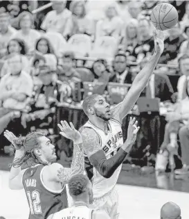  ?? Edward A. Ornelas / San Antonio Express-News ?? The Spurs’ LaMarcus Aldridge, right, scores two of his game-high 38 points as San Antonio never trailed Saturday night en route to dominating the Thunder.