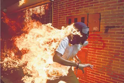  ?? PHOTO: RONALDO SCHEMIDT, AGENCE FRANCEPRES­SE VIA REUTERS ?? Venezuela burning . . . Winner of the World Press Photo of the Year 2018 contest and first prize for Spot News Singles, Ronaldo Schemidt’s image shows Jose Victor Salazar Balza (28) catching fire amid violent clashes during a protest against President...