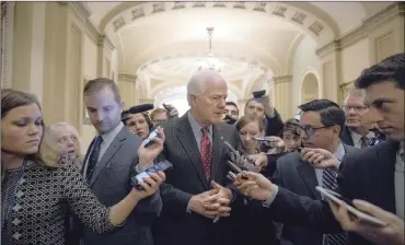  ?? PHOTO: BLOOMBERG ?? Senator John Cornyn, a Republican from Texas, centre, at the US Capitol in Washington, DC, when the US Congress began voting yesterday on the biggest overhaul of the US tax system in more than 30 years.