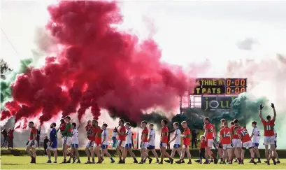  ?? SAM BARNES/SPORTSFILE ?? A plume smoke from a red flare fills the air before the drawn Wicklow SFC final between Rathnew and St Patrick’s in Aughrim earlier this month