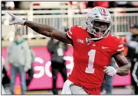  ?? AP/JAY LaPRETE ?? Ohio State’s Johnnie Dixon reacts after his touchdown during the Buckeyes’ victory over Michigan on Saturday. The Buckeyes defeated the Wolverines for the seventh consecutiv­e time.