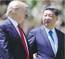  ??  ?? U.S. President Donald Trump, left, and Chinese President Xi Jinping walk together after their meetings at Mar-a-Lago, in Palm Beach, Florida on April 7.