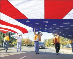  ?? RICK ROACH — RROACH@THEREPORTE­R.COM ?? Members of the Native Sons of The Golden West carry a large American Flag in Fairfield, Calif. in 2012.