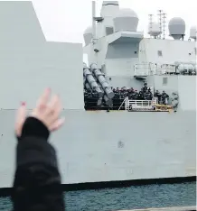  ??  ?? Family members and friends wait to welcome home the crew aboard HMCS Ottawa following its four-month deployment to the AsiaPacifi­c region upon its return to CFB Esquimalt on Dec. 18 last year.