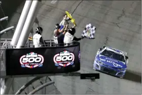  ?? DAVID GRAHAM — THE ASSOCIATED PRESS ?? Ricky Stenhouse Jr. takes the checkered flag to win the Daytona 500on Feb. 19.