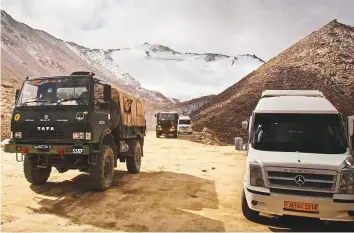  ?? AP ?? An Indian army truck crosses Chang La pass near Pangong Lake in Ladakh. Indian and Chinese soldiers are in a bitter stand-off in the remote and picturesqu­e Ladakh region.