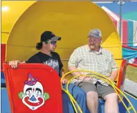  ?? ERIC MCCARTHY/JOURNAL PINEER ?? Prince County Exhibition president Jason Rayner, right, chats with Hinchey’s Rides and Amusements’ midway worker, Kenny “Ducky” Earle. Earle revealed that the Tilt-awhirl was his favourite ride when he was a kid and now he gets to operate the ride. He...