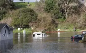  ?? SHMUEL THALER/THE SANTA CRUZ SENTINEL VIA AP ?? Tsunami surge inundates the parking lot at the top of the Upper Harbor in Santa Cruz, Calif., on Saturday. Moments later all the water receded from the lot before flooding it again shortly thereafter.