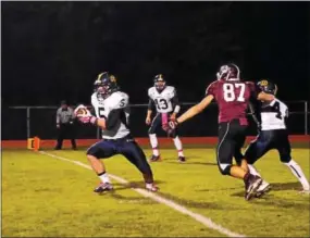  ?? BILL RUDICK -- 21ST CENTURY MEDIA ?? Unionville’s Michael Weber intercepts a pass in front of Oxford receiver Ryan Hubley and returns it 100yards for a touchdown during Friday’s contest.