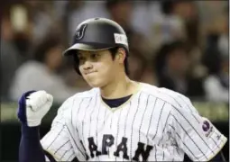  ?? KOJI SASAHARA — THE ASSOCIATED PRESS FILE ?? In this Nov. 12, 2016 photo, Japan’s designated hitter Shohei Otani reacts after hitting a solo home run off Netherland­s’ starter Jair Jurrjens in the fifth inning of their internatio­nal exhibition series baseball game in Tokyo.