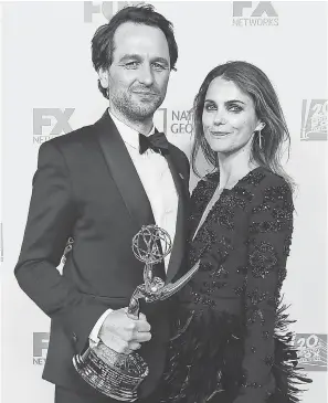  ?? FREDERIC J. BROWN/AFP/GETTY IMAGES ?? Matthew Rhys (“The Americans”) arrives for a party with Keri Russell after being named outstandin­g lead actor in a drama series.