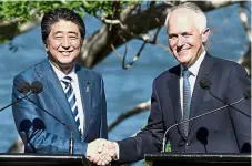  ?? — AFP ?? Collaborat­ive effort: Turnbull shaking hands with Abe after a joint press conference in Sydney.