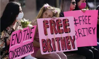  ??  ?? #FreeBritne­y participan­ts outside a court hearing about the pop star’s conservato­rship in LA last month. Photograph: Chris Pizzello/AP