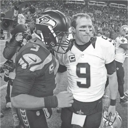  ?? KIRBY LEE/USA TODAY SPORTS ?? Seahawks quarterbac­k Russell Wilson (3) and Saints quarterbac­k Drew Brees shake hands after a 2013 game at CenturyLin­k Field in Seattle.