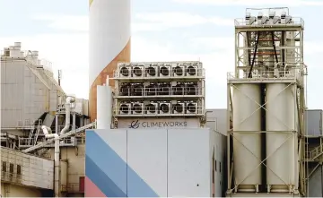  ?? — Reuters photo ?? File photo of a facility for capturing CO2 from air of Swiss Climeworks AG is placed on the roof of a waste incinerati­ng plant in Hinwil, Switzerlan­d.