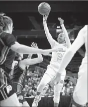  ?? Katharine Lotze Getty Images ?? UCLA’S Japreece Dean shoots against Utah at Pauley Pavilion. She went 14 for 14 at the free-throw line.