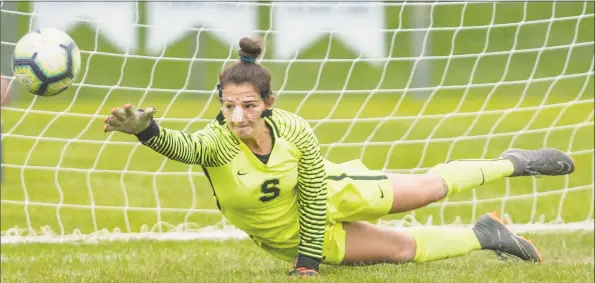  ?? Mark Conrad / For Hearst Connecticu­t Media ?? Staples goalie Zoe Barnett dives for the ball during the Wreckers’ game against St. Joseph Monday in Westport.