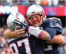  ?? JIM ROGASH/GETTY IMAGES ?? Tom Brady and Rob Gronkowski could have plenty to celebrate this season, with some favouring the Patriots to win all of their regular-season games.