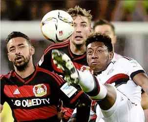  ?? — reuters ?? High anxiety: David Alaba going for the ball as Bayer Leverkusen’s Karim Bellarabi (left) and Christoph Kramer look on during the Bundesliga match on Saturday.