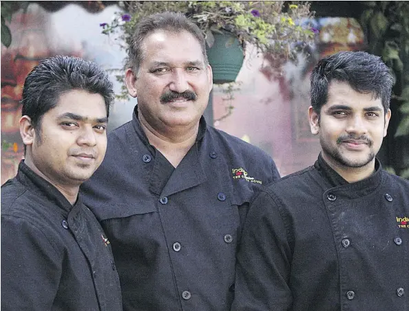  ?? PHOTOS: CLAIRE THEOBALD ?? Parkash Chhibber, centre, stands with staff members Purvak Patel, left, and Abhishek Gaekwad at the Indian Fusion — The Curry House at 10322 111 St. Chhibber began offering free meals to those in need out of the back of his restaurant three years ago, the same food he serves to his paying customers, and now serves as many as 1,600 hot meals to those in need every month.