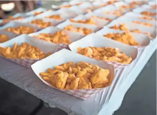  ?? MILWAUKEE JOURNAL SENTINEL ?? Cheese curds are lined up on the table before a cheese curd eating contest at the 2018 Wisconsin State Fair. This fair favorite will be available during the Fair Food Drive-Thru in August.