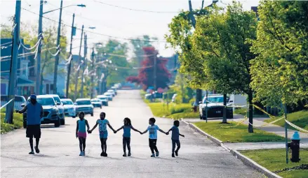  ?? MATT ROURKE/AP ?? Children walk in a street May 15 near the scene of the Buffalo, New York, supermarke­t shooting the day prior.