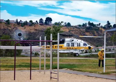  ?? Cory Rubin /The Signal (See additional photos at signalscv.com) ?? A child is airlifted from Plum Canyon Elementary by Los Angeles County Fire Department’s Copter 15 after he fell in a pool and had difficulty breathing. Officials responded Friday to a separate report of a toddler drowning.